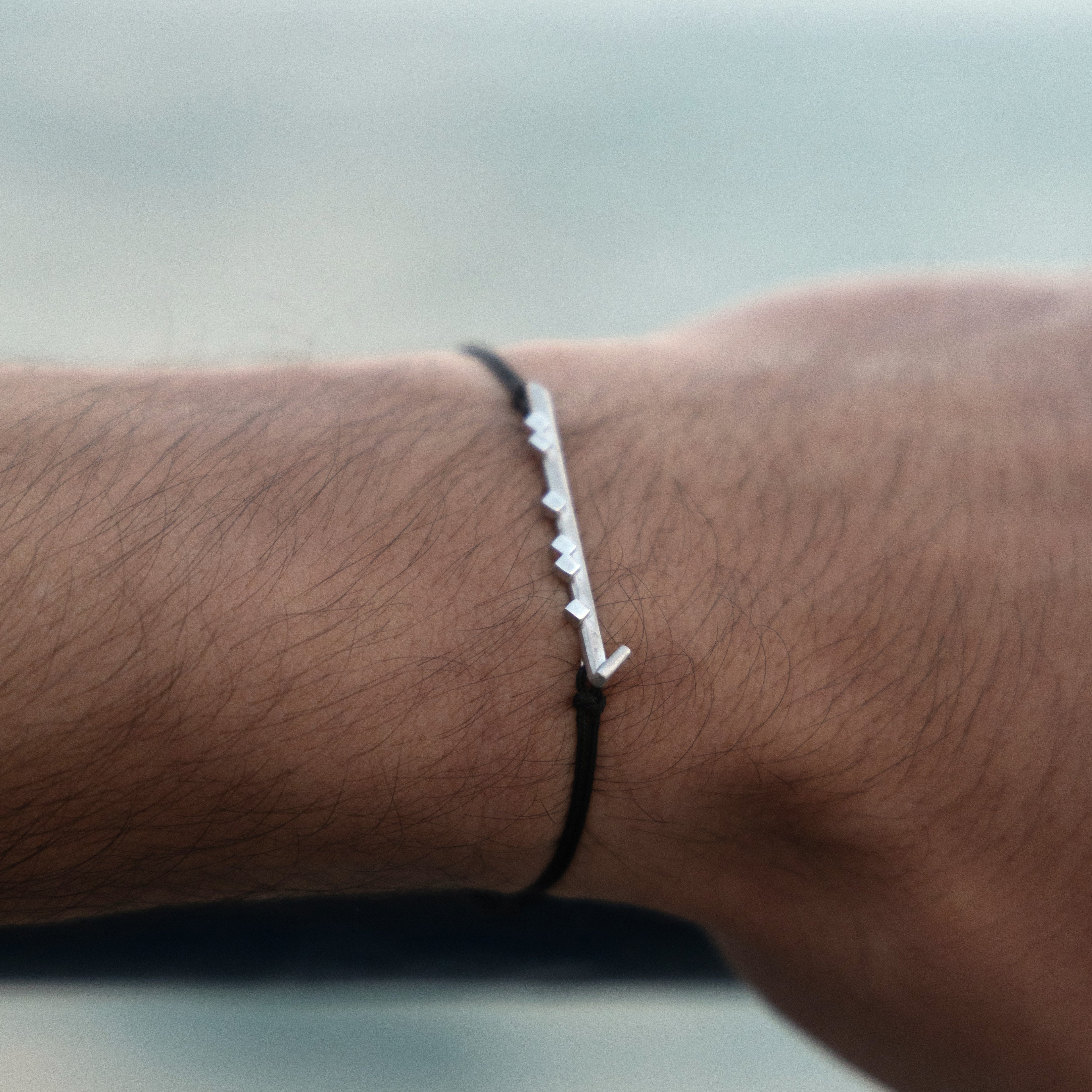ël_Habibi bracelet in brushed silver with a black thread