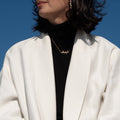 ël_Stillness earring in brushed white gold
ël_I adore you horizontal necklace in sand-blasted yellow gold